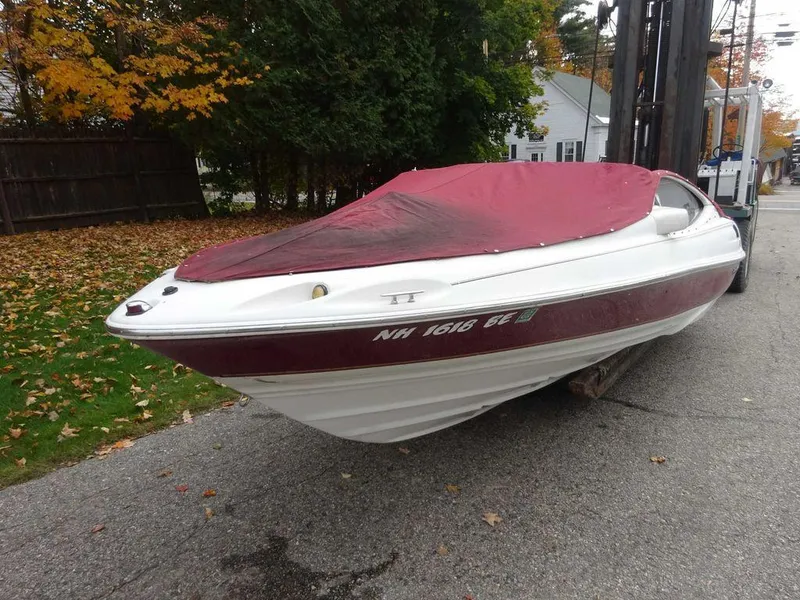 Slide: The Image of 2000 Regal 2100 LSR boat with red cover on a street in autumn. - 17