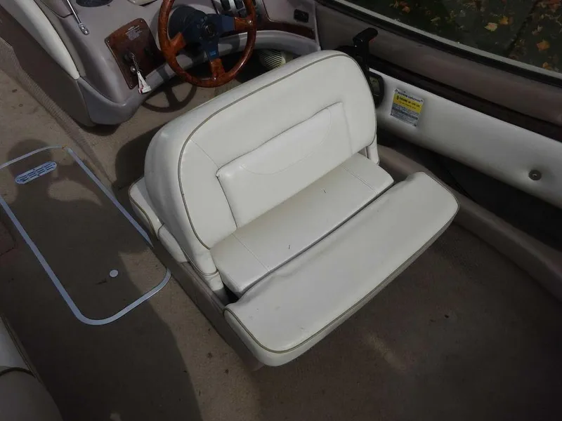 Slide: The Image of 2000 Regal 2100 LSR boat interior with white leather seats and wooden steering wheel. - 18