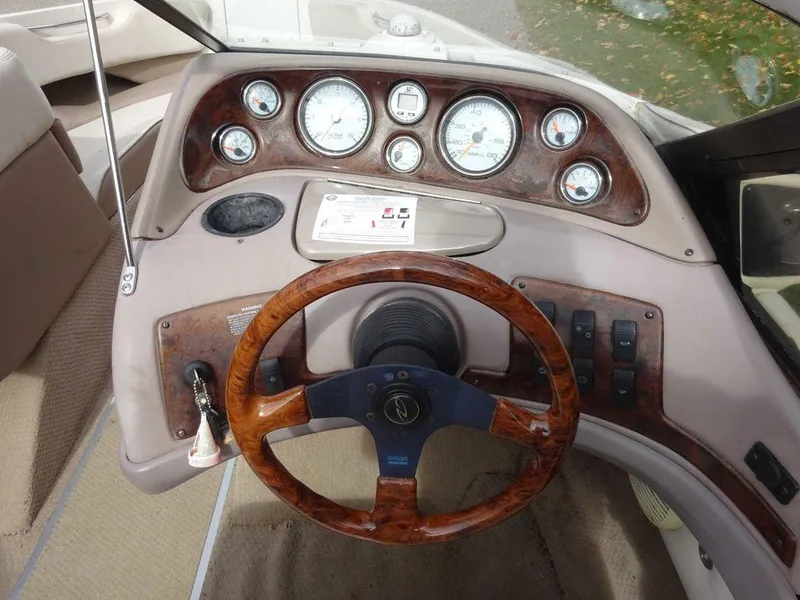 Slide: The Image of Dashboard of a 2000 Regal 2100 LSR boat with wood-trimmed steering wheel. - 4