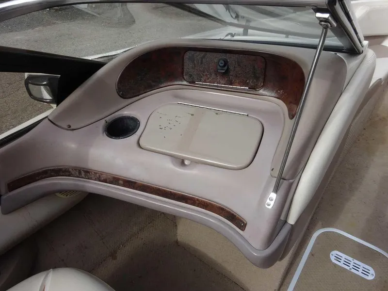 Slide: The Image of Interior of a 2000 Regal 2100 LSR boat showing dashboard and storage compartment. - 5