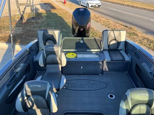 Slide: The Image of 2024 Lund 189 Tyee GL boat interior with seating and motor. - 12