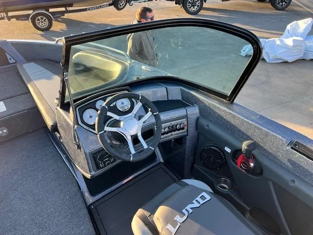 Slide: The Image of 2024 Lund 189 Tyee GL boat interior with steering wheel and dashboard. - 13