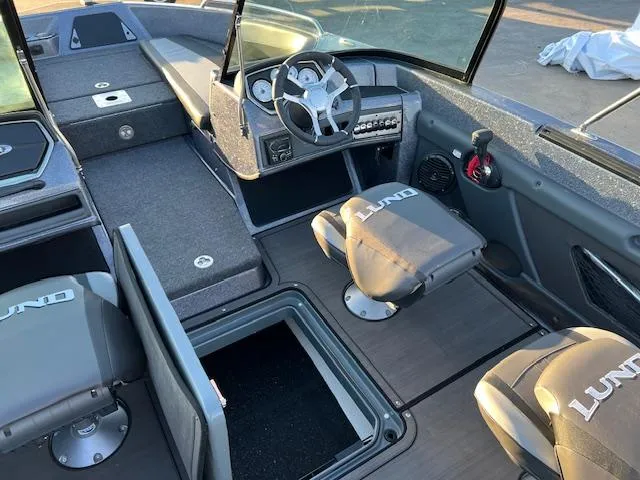 Slide: The Image of 2024 Lund 189 Tyee GL boat interior with steering console and seating. - 14