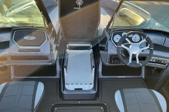 Slide: The Image of 2024 Lund 189 Tyee GL boat interior with steering wheel and seating. - 16