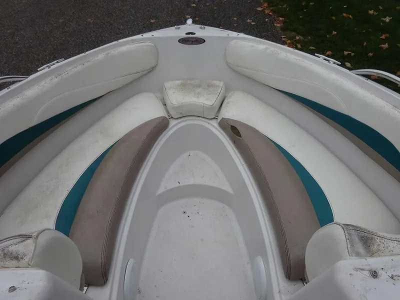 Slide: The Image of 1998 Four Winns 200 Horizon boat bow seating area with white and teal upholstery. - 10