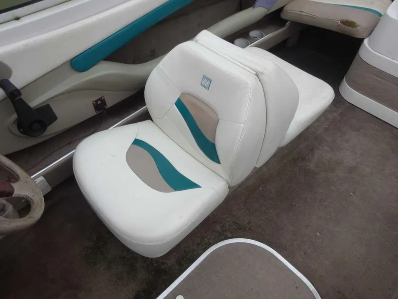 Slide: The Image of 1998 Four Winns 200 Horizon boat interior with white and teal seating. - 12