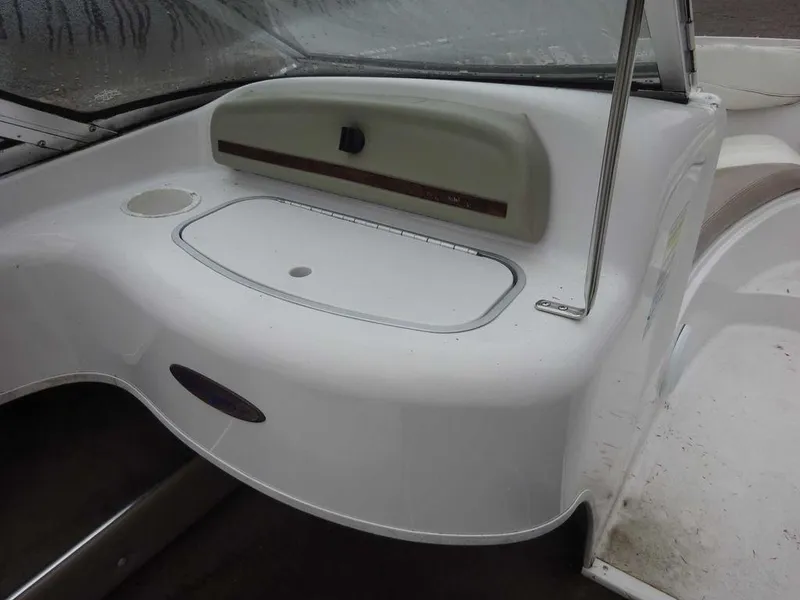 Slide: The Image of 1998 Four Winns 200 Horizon boat interior, white dashboard and storage compartment. - 13
