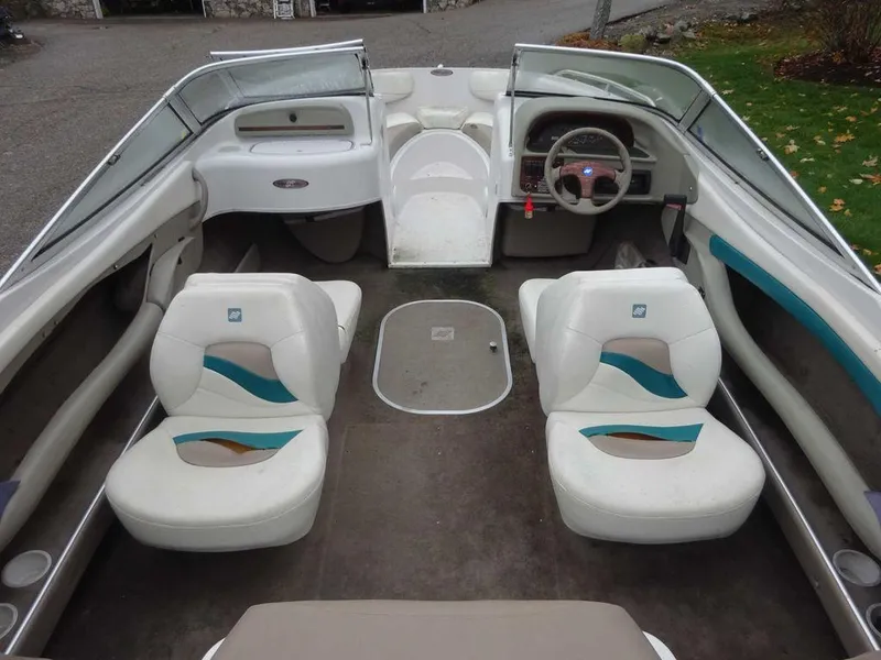 Slide: The Image of 1998 Four Winns 200 Horizon boat interior with white and teal seating. - 14
