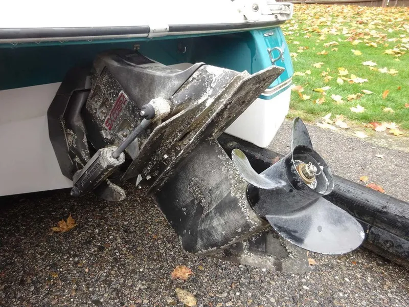 Slide: The Image of 1998 Four Winns 200 Horizon boat propeller and stern drive with visible wear. - 6