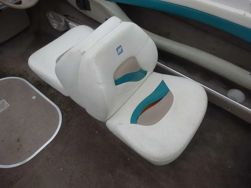 Slide: The Image of 1998 Four Winns 200 Horizon boat interior seat with white and teal upholstery. - 7