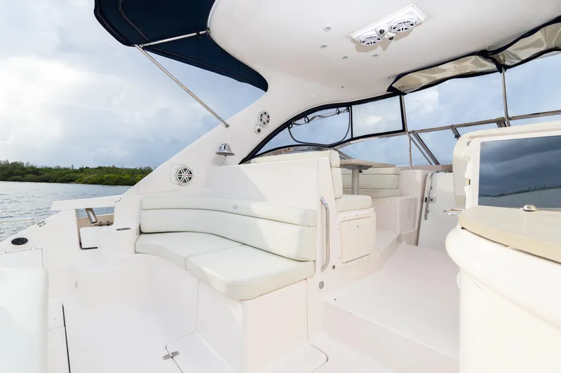 Slide: The Image of 2004 Regal 4260 Commodore yacht interior with white seating and canopy. - 12