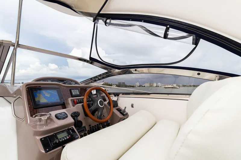 Slide: The Image of 2004 Regal 4260 COMMODORE yacht cockpit with navigation equipment and city skyline view. - 14