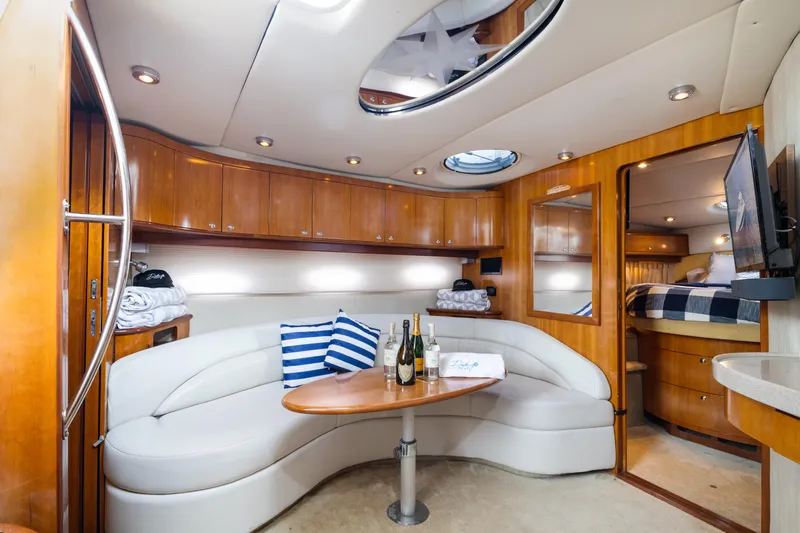 Slide: The Image of Luxurious interior of 2004 Regal 4260 Commodore yacht with plush seating and wooden cabinetry. - 15