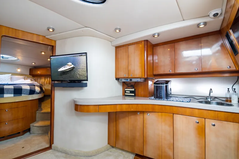 Slide: The Image of 2004 Regal 4260 COMMODORE yacht interior with kitchen and bedroom. - 16