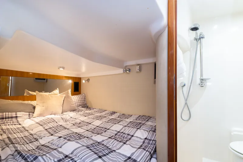 Slide: The Image of 2004 Regal 4260 Commodore yacht interior cabin with bed and shower. - 18