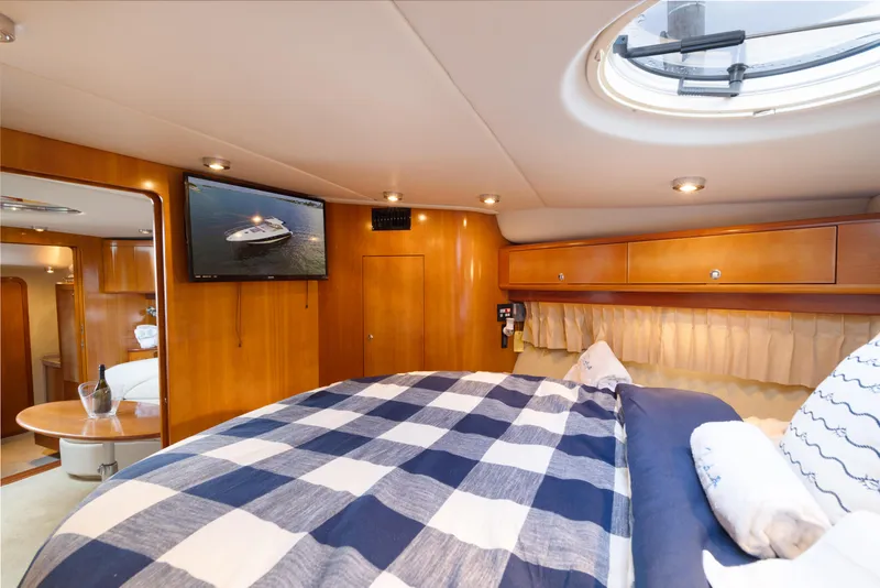 Slide: The Image of Luxurious bedroom interior of 2004 Regal 4260 Commodore yacht with TV and porthole. - 20