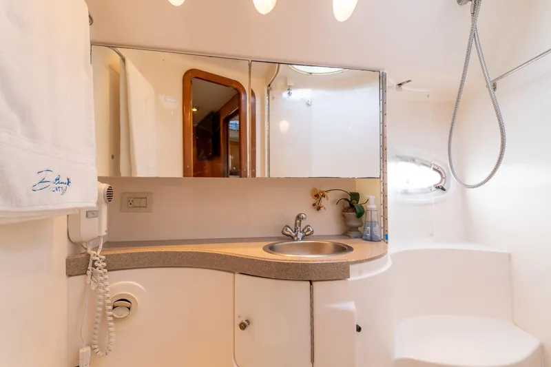 Slide: The Image of 2004 Regal 4260 Commodore yacht bathroom with sink, mirror, and shower. - 21