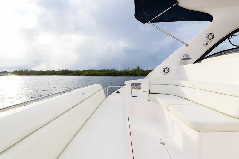 Slide: The Image of 2004 Regal 4260 COMMODORE yacht with white seating, on a calm water body. - 8