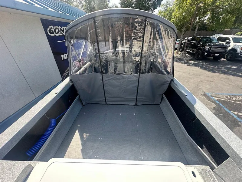Slide: The Image of KingFisher 2025 Escape boat, 2024 model, with covered seating area and modern design. - 14