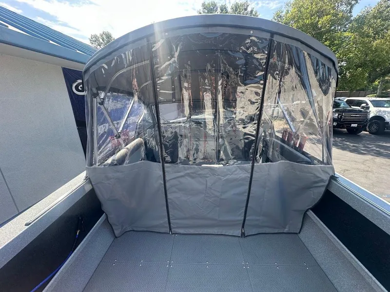 Slide: The Image of 2024 KingFisher 2025 Escape boat with protective canopy in a sunny outdoor setting. - 16
