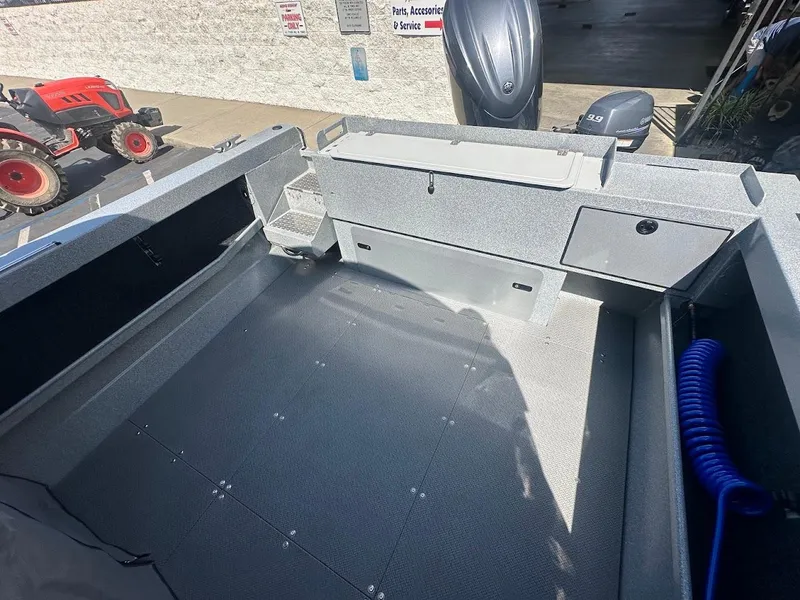 Slide: The Image of 2024 KingFisher 2025 Escape boat interior with storage compartments and motor. - 17