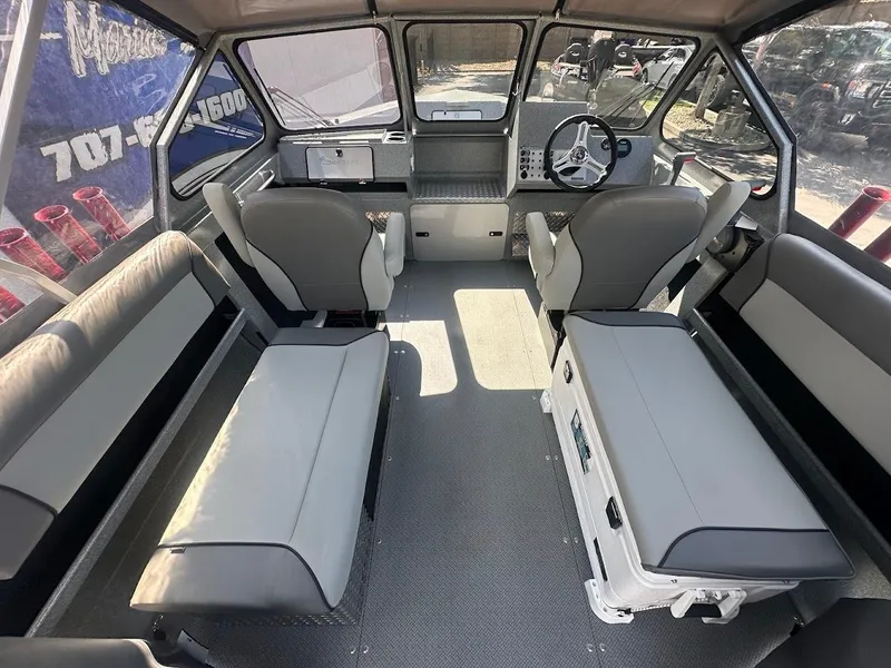 Slide: The Image of Interior of 2024 KingFisher 2025 Escape boat with seating and steering console. - 25