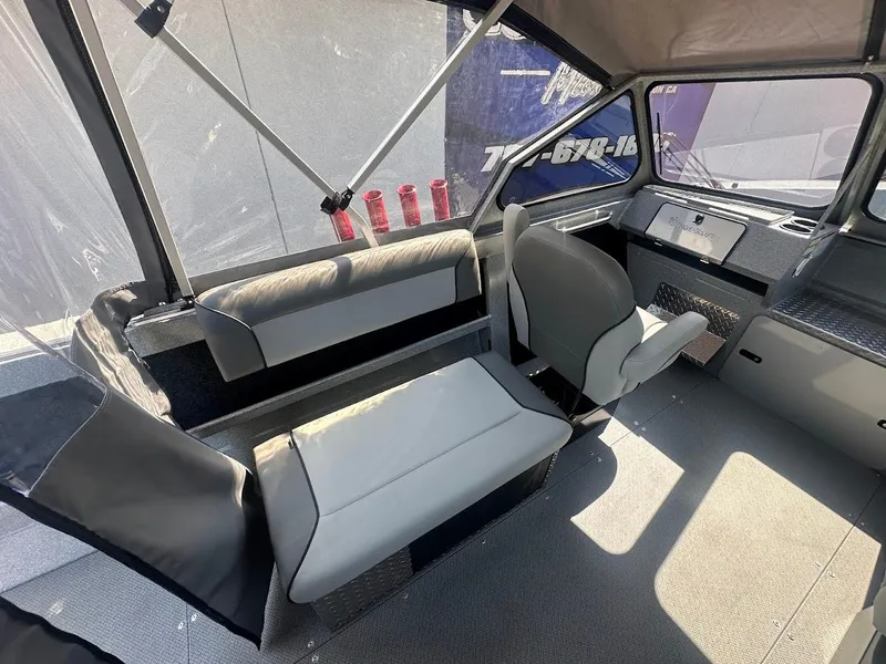 Slide: The Image of Interior of 2024 KingFisher 2025 Escape boat with seating and dashboard. - 26