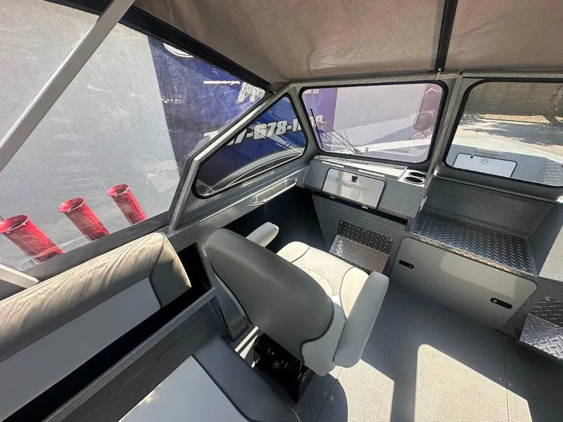 Slide: The Image of Interior of 2024 KingFisher 2025 Escape boat, featuring modern seating and dashboard. - 27