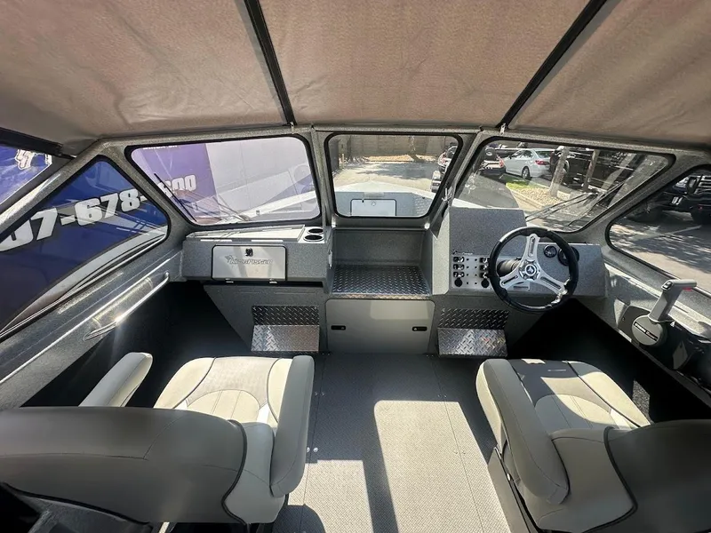 Slide: The Image of Interior of 2024 KingFisher 2025 Escape boat, featuring modern seating and steering console. - 28