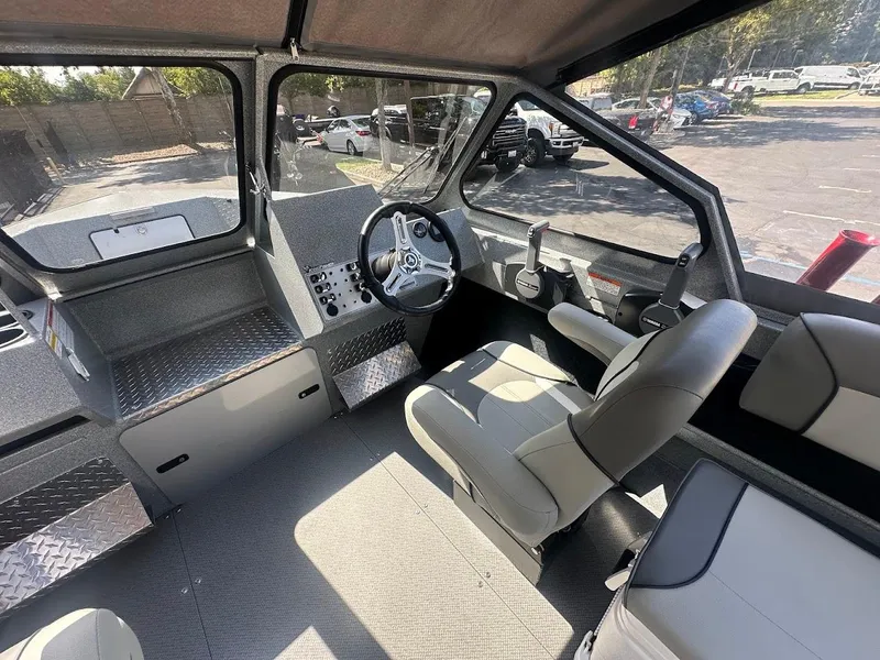 Slide: The Image of Interior of 2024 KingFisher 2025 Escape boat, featuring modern steering and seating. - 29