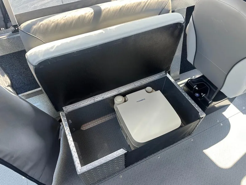 Slide: The Image of KingFisher 2025 Escape boat interior with storage compartment and portable toilet, 2024 model. - 32