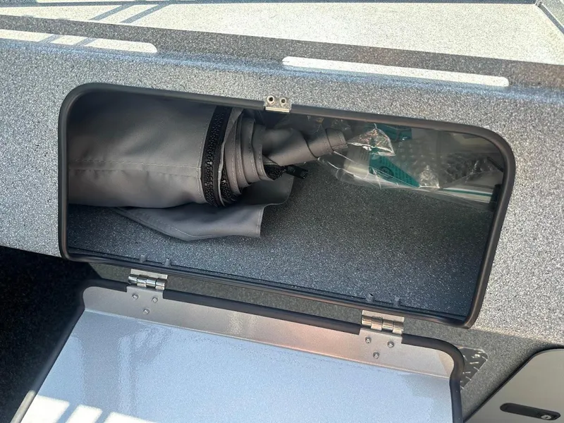 Slide: The Image of Storage compartment in 2024 KingFisher 2025 Escape boat, containing rolled-up cover. - 34