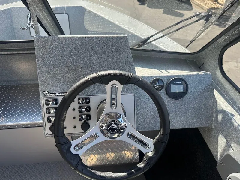 Slide: The Image of KingFisher 2025 Escape boat dashboard with steering wheel and control panel, 2024 model. - 36