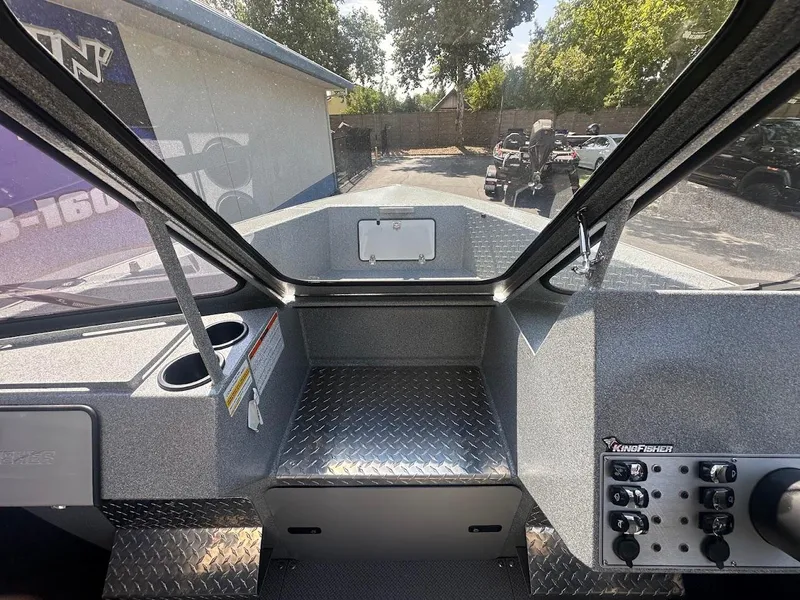 Slide: The Image of Interior view of 2024 KingFisher 2025 Escape boat, featuring control panel and seating area. - 39