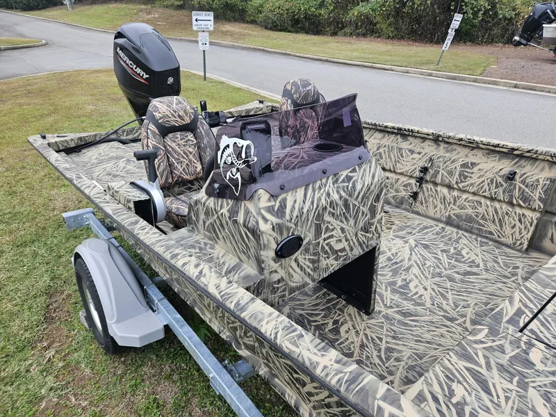 Slide: The Image of 2021 Lund 1760 Predator SC boat with camo design and Mercury outboard motor. - 3