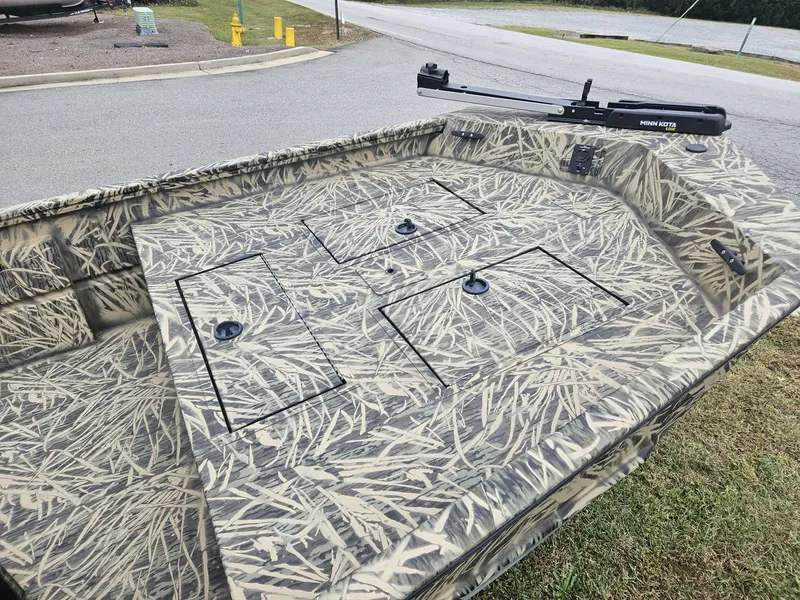 Slide: The Image of 2021 Lund 1760 Predator SC boat with camo pattern and Minn Kota trolling motor. - 7