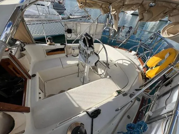 Slide: The Image of 1986 Pacific Seacraft 37 sailboat cockpit with steering wheel and seating. - 5