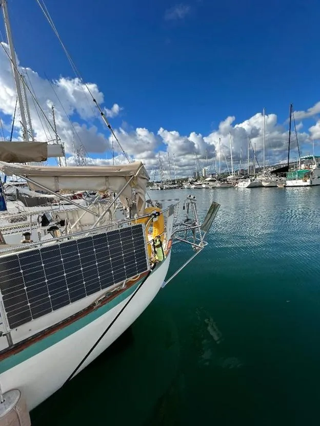 Slide: The Image of 1986 Pacific Seacraft 37 sailboat docked in a marina with solar panels. - 8