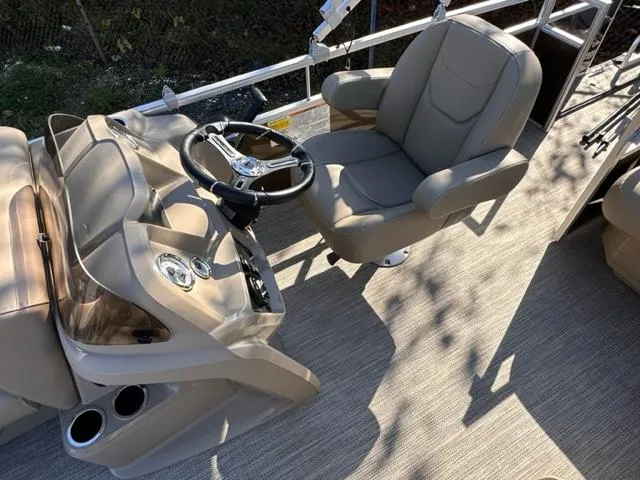 Slide: The Image of 2024 Starcraft LX 20 CB boat helm with captain's chair and steering wheel. - 4