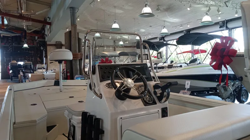 Slide: The Image of 2024 Ranger RB200 boat interior in showroom with steering console and seating. - 3