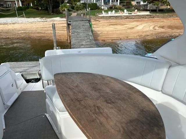 Slide: The Image of 2010 Regal 3060 Window Express boat with dock and beach in background. - 10
