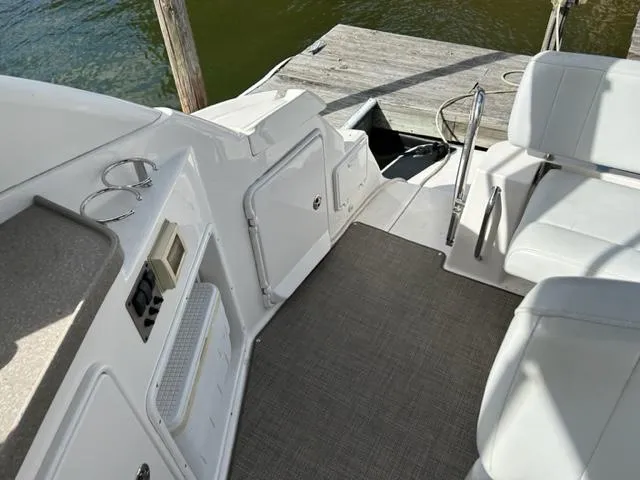 Slide: The Image of Interior view of 2010 Regal 3060 Window Express boat docked by the water. - 13
