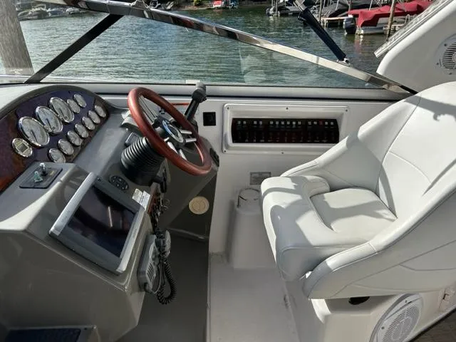 Slide: The Image of 2010 Regal 3060 Window Express boat helm with steering wheel and control panel. - 16