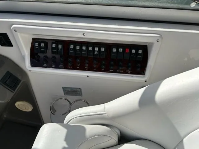 Slide: The Image of Control panel of a 2010 Regal 3060 Window Express boat with white seating. - 17