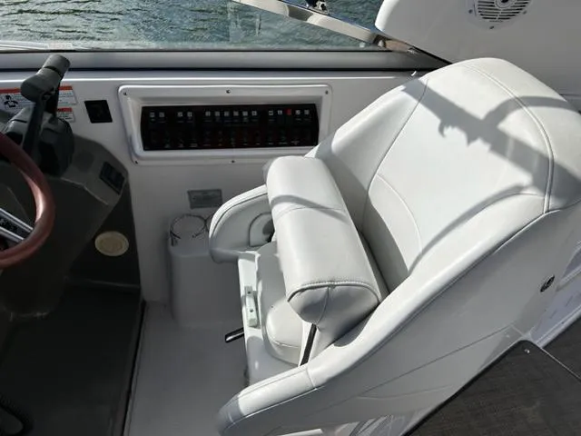 Slide: The Image of Captain's chair and control panel on a 2010 Regal 3060 Window Express boat. - 18