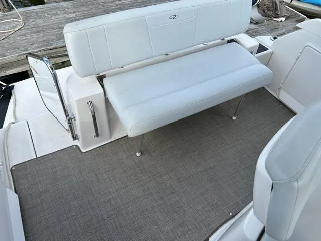 Slide: The Image of 2010 Regal 3060 Window Express boat interior with white seating and gray carpet. - 21