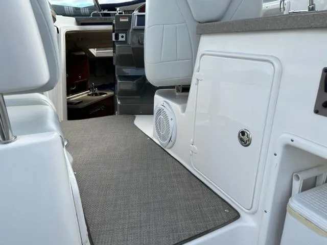 Slide: The Image of Interior of 2010 Regal 3060 Window Express boat, featuring seating and cabin entrance. - 22