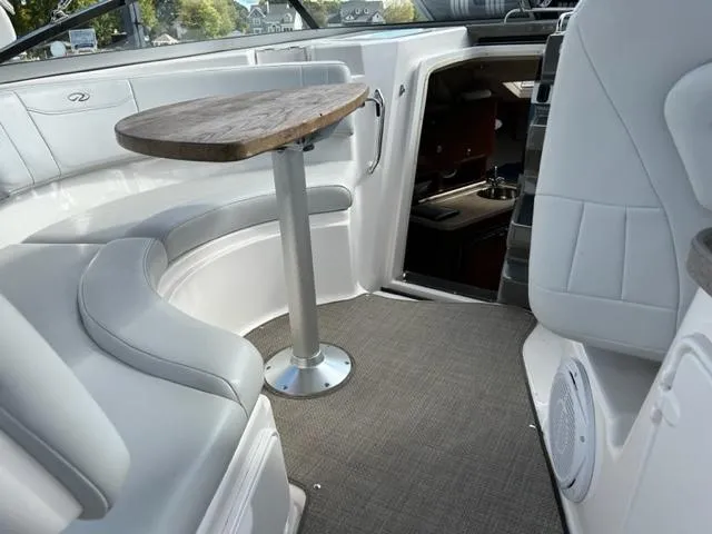 Slide: The Image of Interior of 2010 Regal 3060 Window Express boat with seating and table. - 23