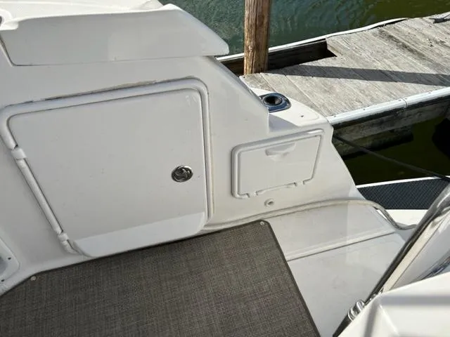 Slide: The Image of 2010 Regal 3060 Window Express boat interior, showing storage compartments and dock. - 28