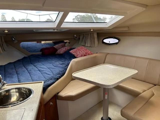 Slide: The Image of Interior of 2010 Regal 3060 Window Express boat with bed, seating, and table. - 29